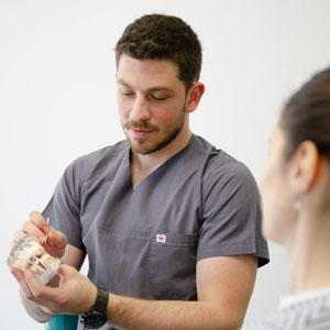 Dentist explaining veneers and implants to a patient