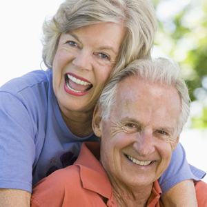 A couple smiles. Do they have dentures or dental implants?