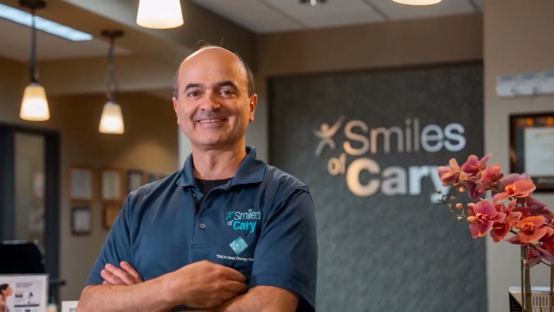 Dr. Charles Ferzli at the front desk of Smiles of Cary in Cary, NC