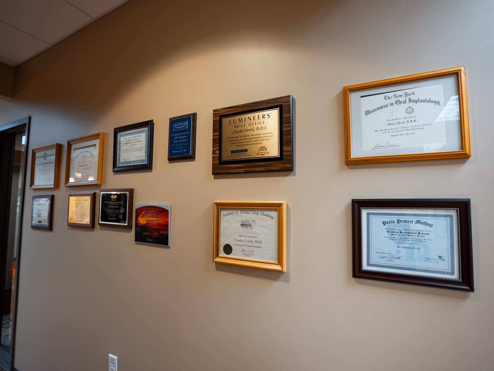 Dr. Charles Ferzli's certificates and credentials on the wall at Smiles of Cary in Cary, NC