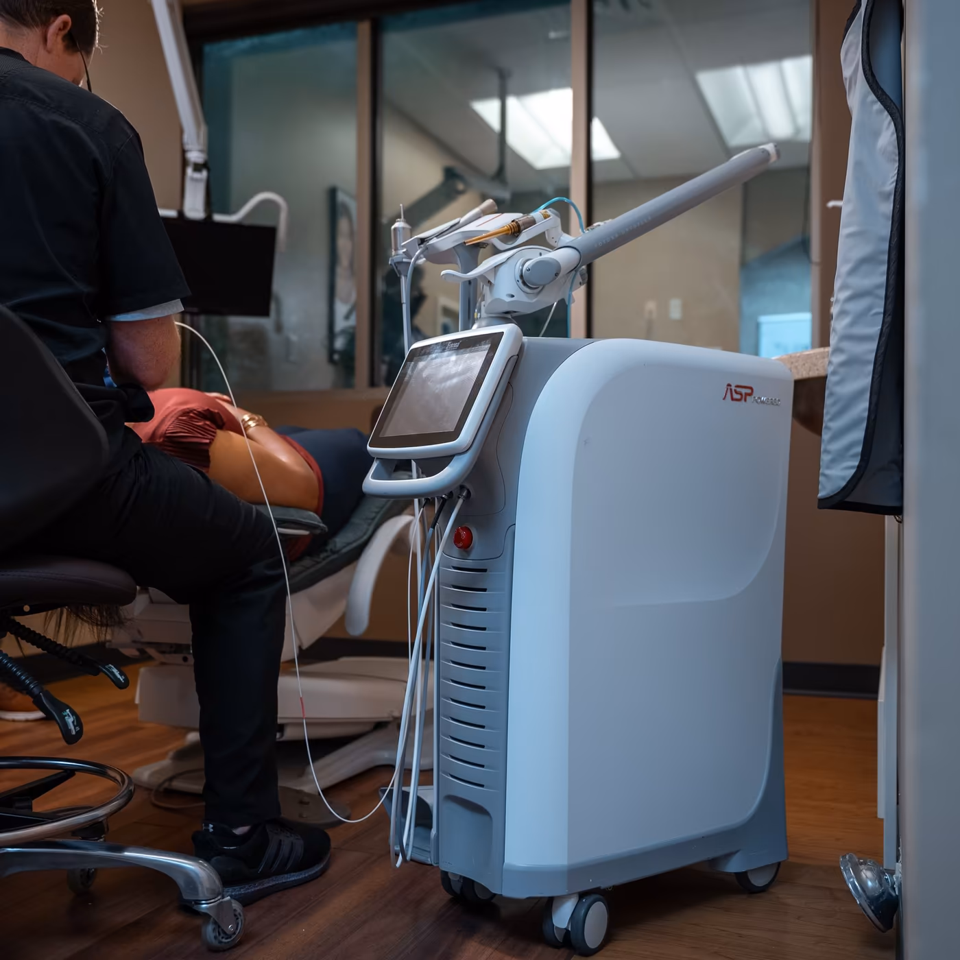 A dental laser in use in a treatment room at Smiles of Cary