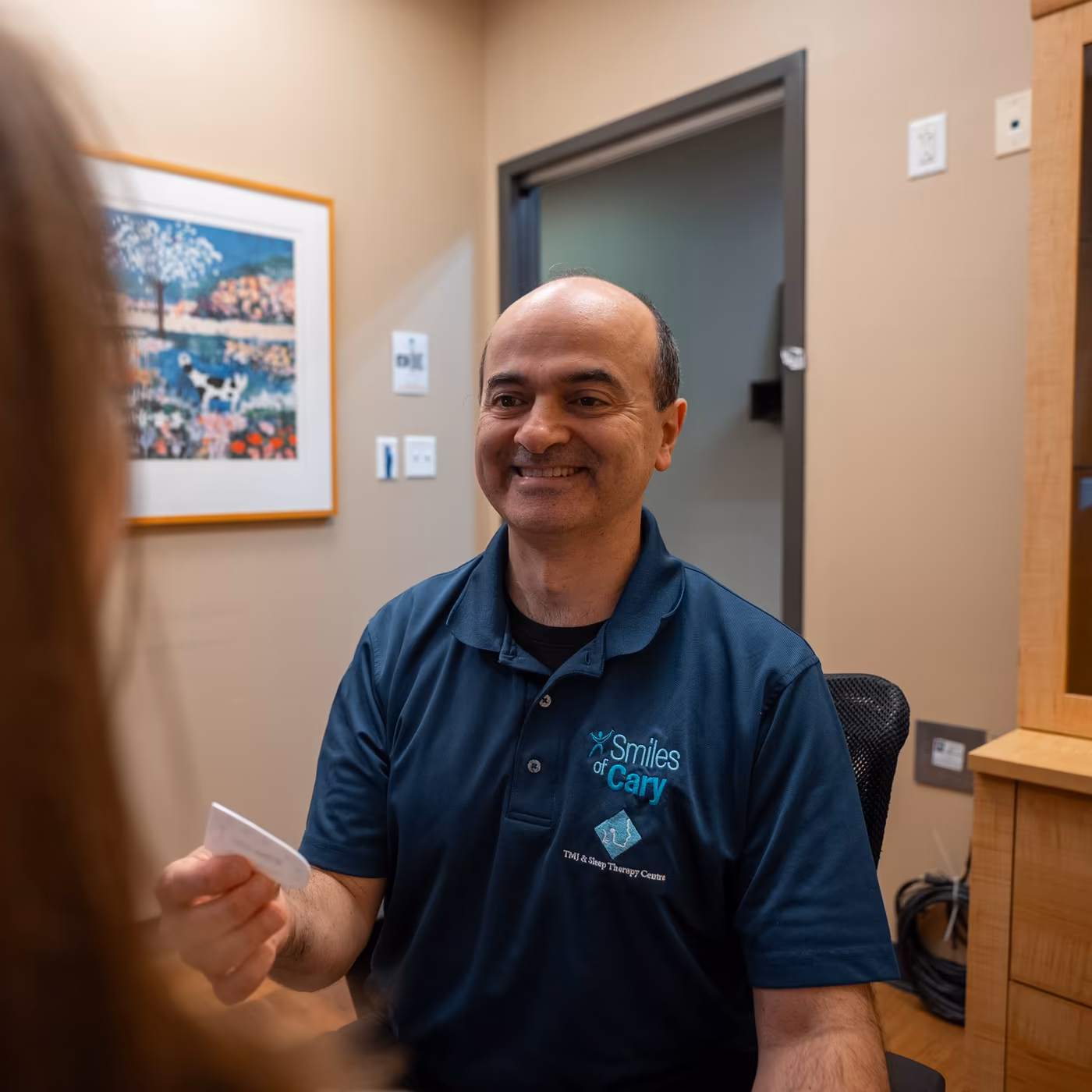 Dr. Charles Ferzli going over results with a patient at Smiles of Cary