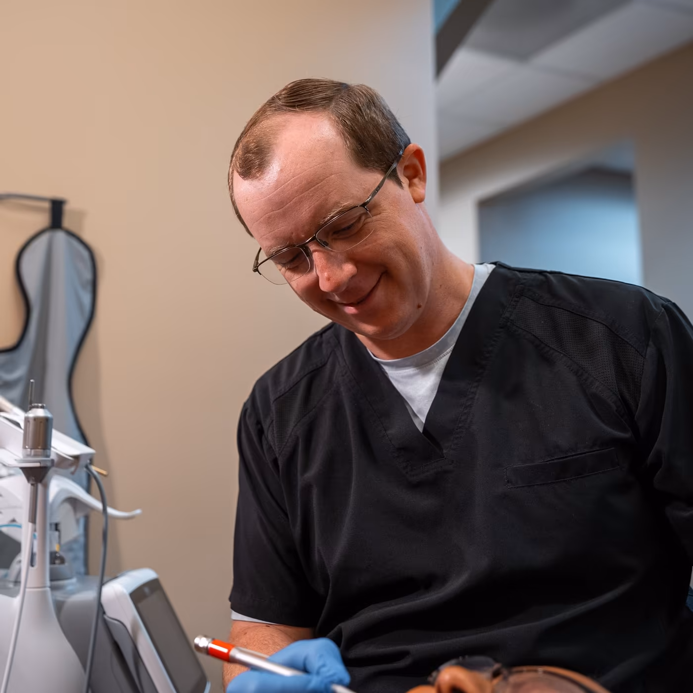 Dr. Jordan Lee working chairside on a patient's treatment at Smiles of Cary
