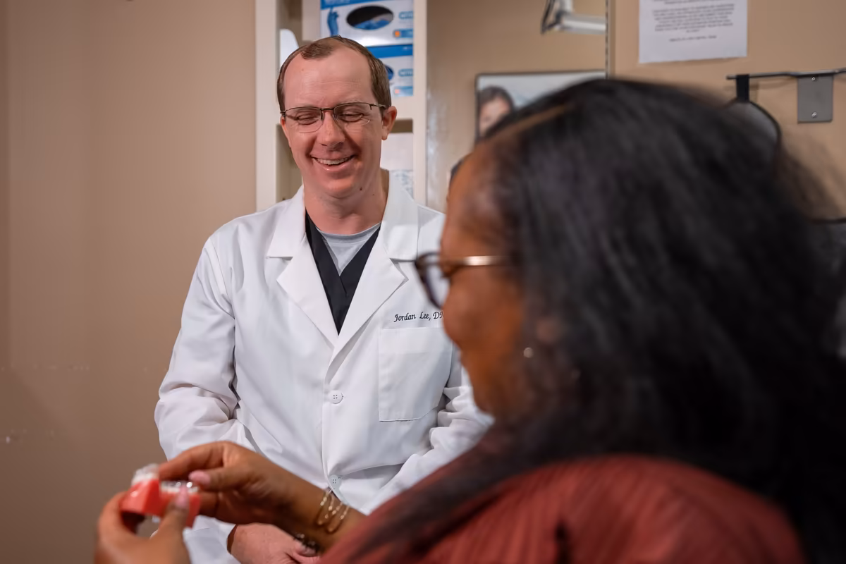 Dr. Jordan Lee showing a patient a dental model at Smiles of Cary