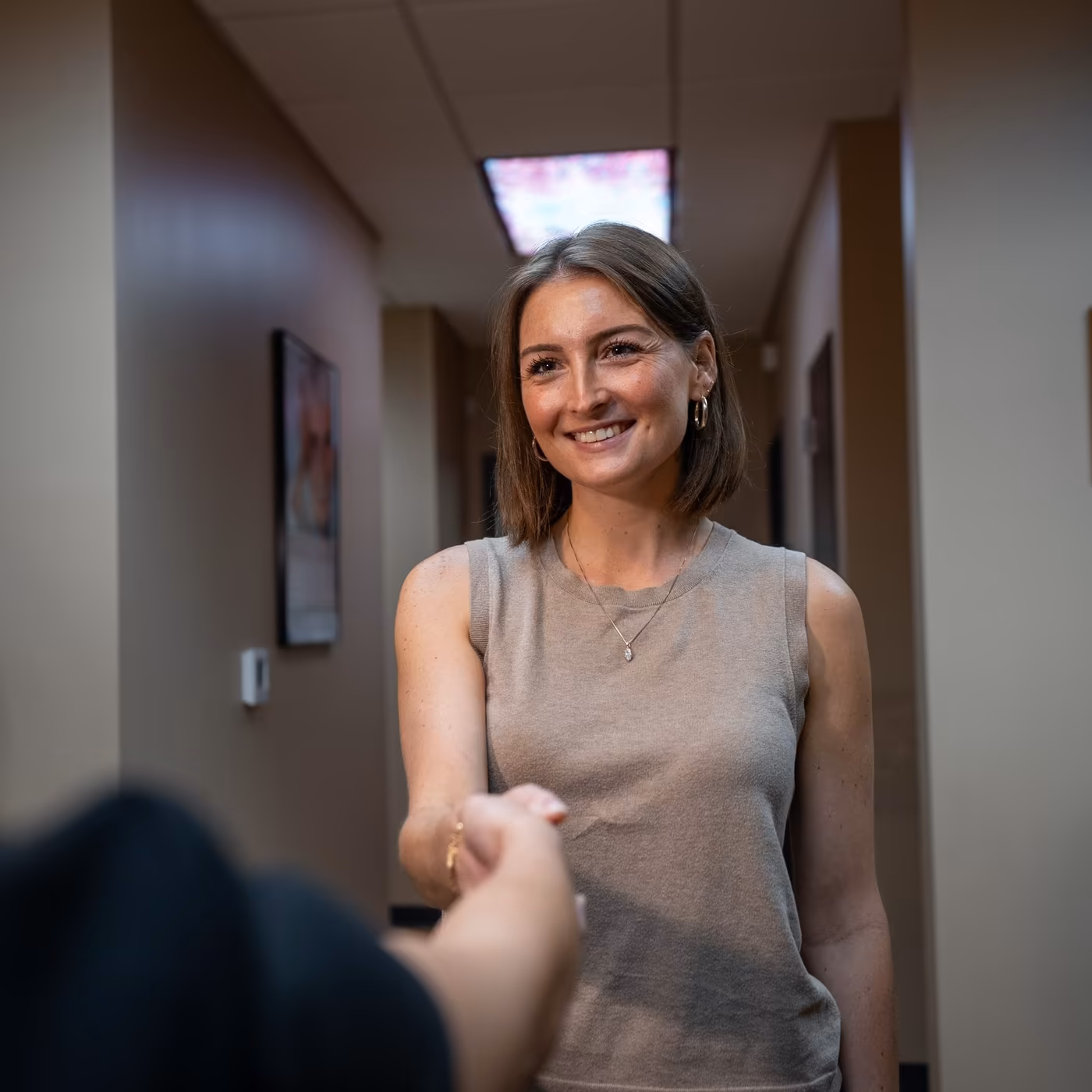 A team member greeting a patient at Smiles of Cary