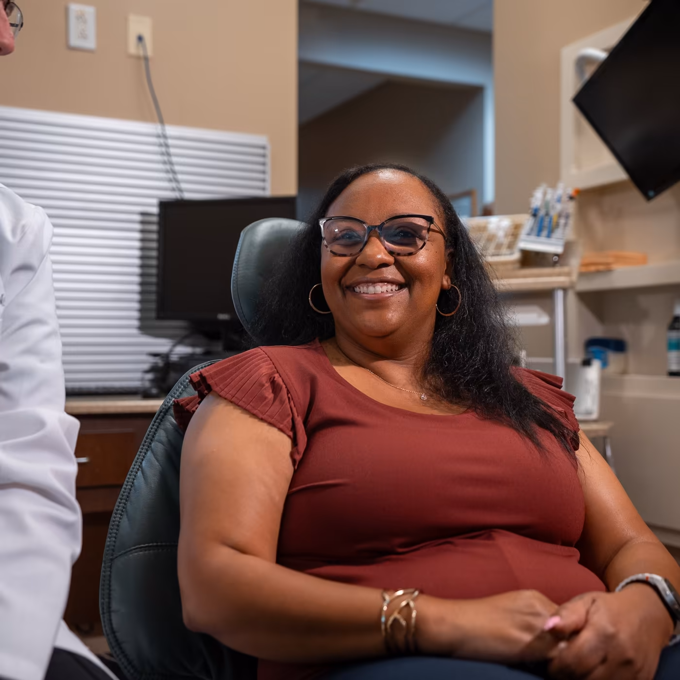 A patient smiling in the treatment chair at Smiles of Cary